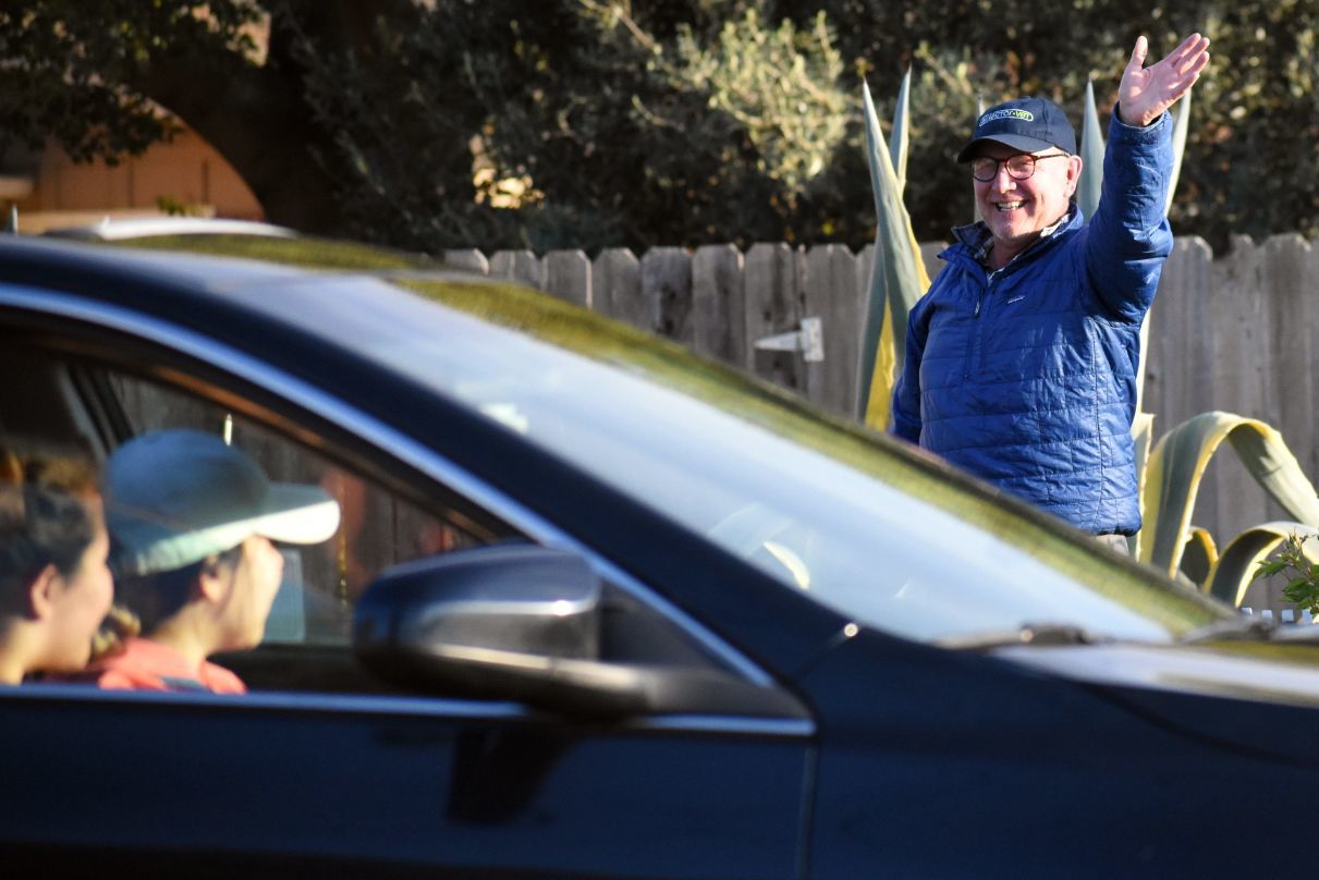 Neighbors wave to each other during the 3rd Cruise Los Alamos parade Saturday evening.